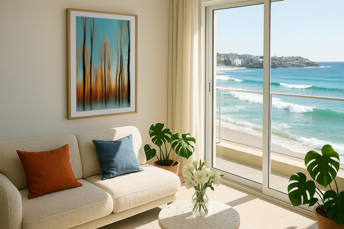 Forest in Motion wall art print, framed with a white border, in a cream sofa plants