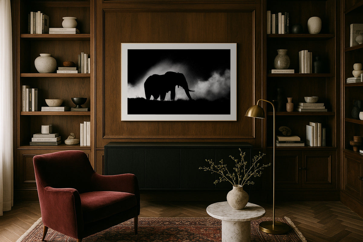 Silhouette in the Dust wall art print, framed with a white border, in a dark wood office leather chair