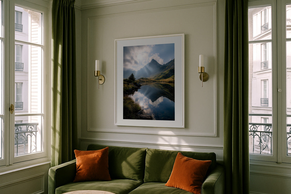Alpine Lake Reflection wall art print, framed with a white border, in a bedside window light