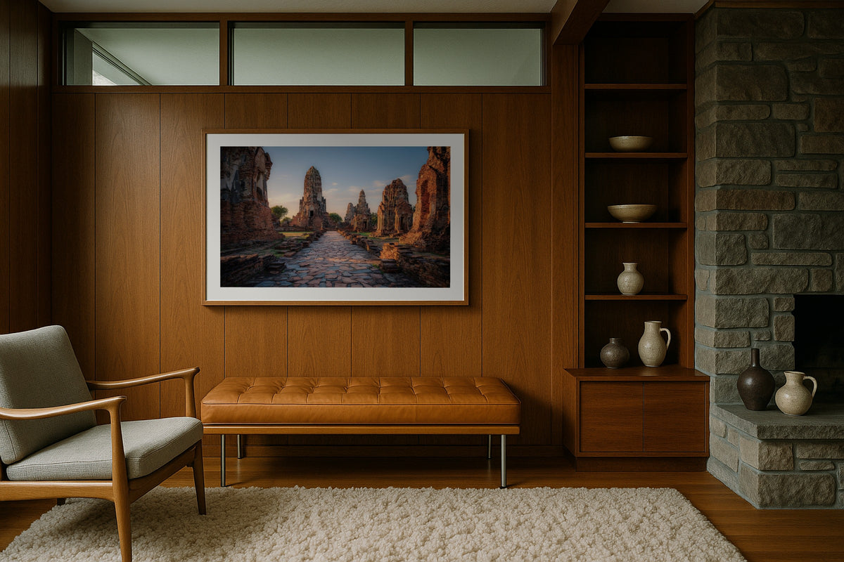 Ayutthaya Ruins wall art print, framed with a white border, in a midcentury stone fireplace