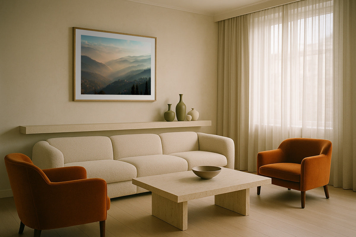 Darjeeling at Sunrise wall art print, framed with a white border, in a cream sofa rust chairs
