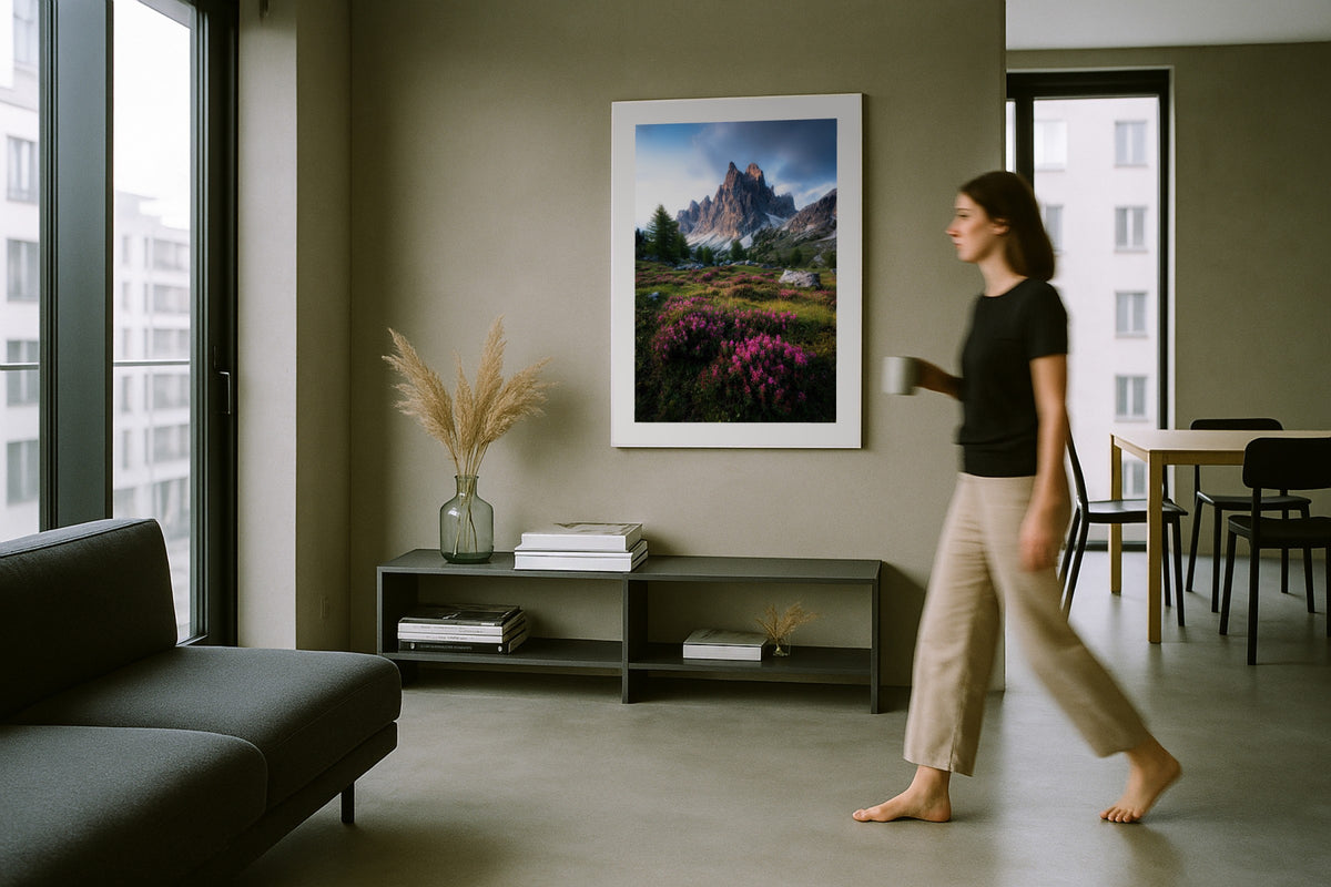 Cadini di Misurina wall art print, framed with a white border, in a woman walking modern grey room
