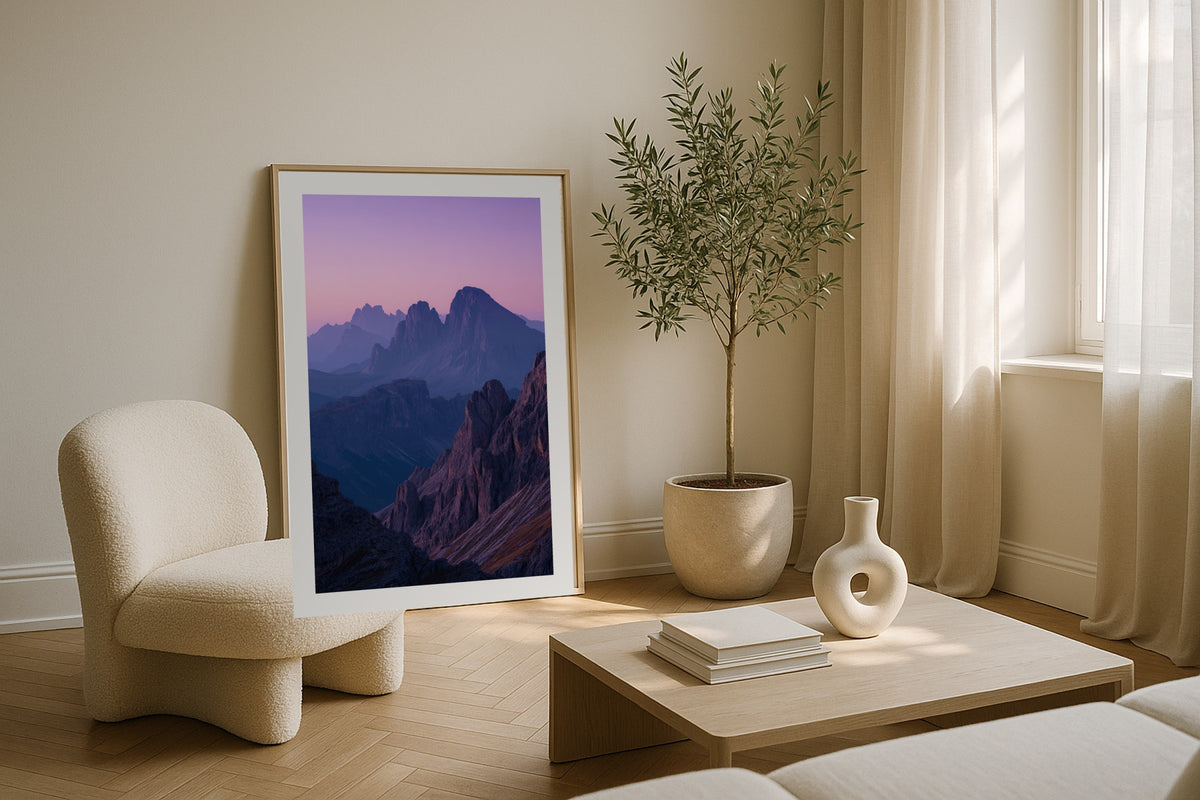 Dolomites at Dusk wall art print, framed with a white border, in a lake view armchair
