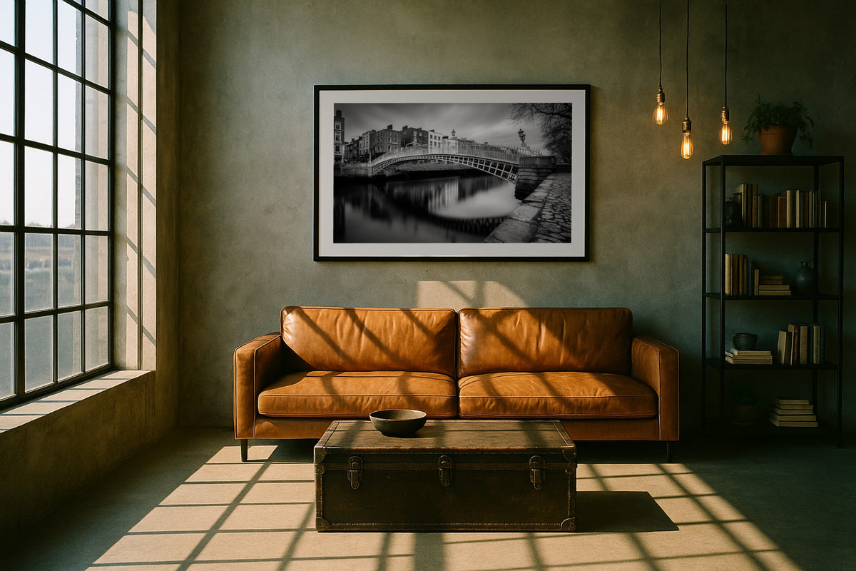 Ha’penny Bridge wall art print, framed with a white border, in a loft leather sofa
