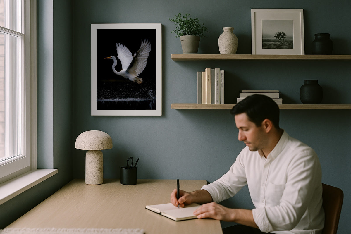 White Bird wall art print, framed with a white border, in a man writing blue wall