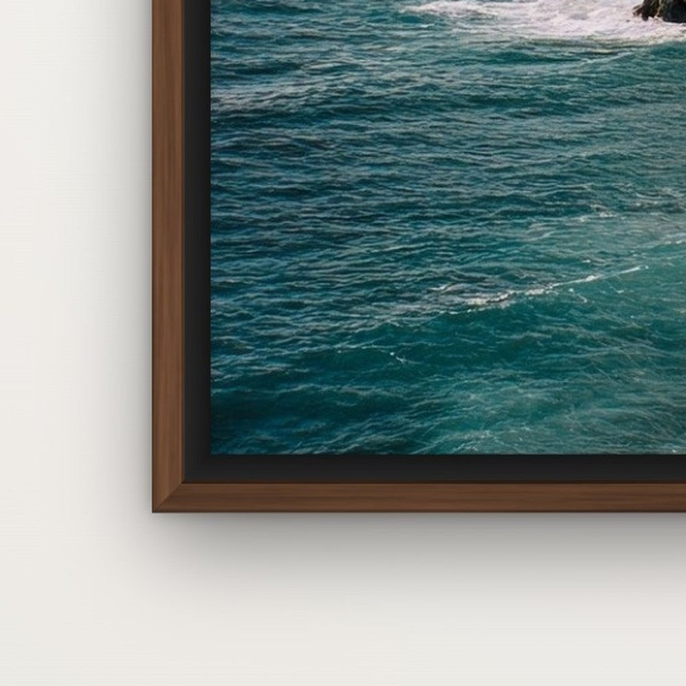 Corner of a dark wood floating frame around a canvas