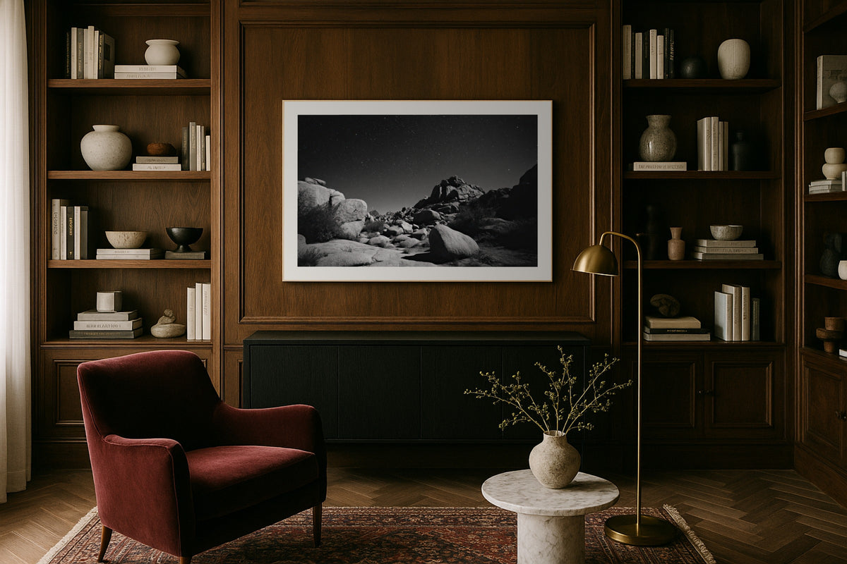 Joshua Tree in Monochrome wall art print, framed with a white border, in a library wood panels velvet chair