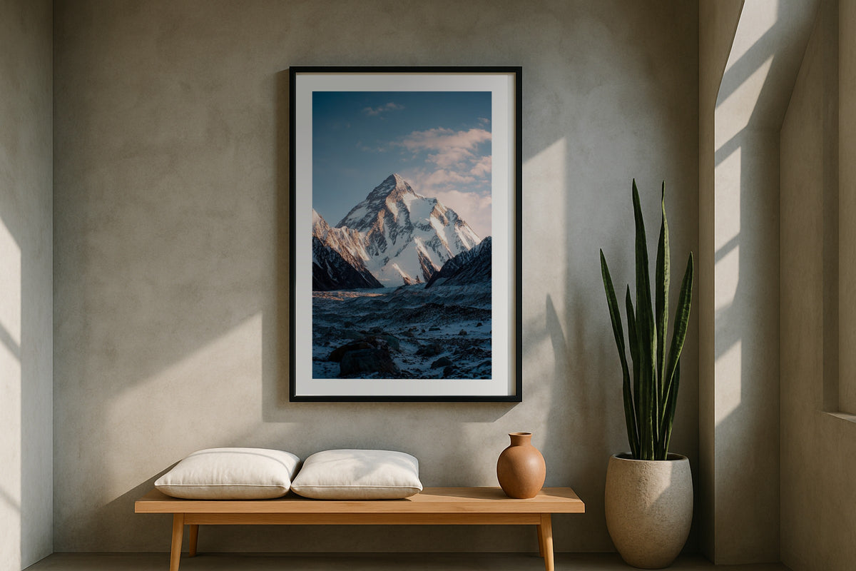 K2 wall art print, framed with a white border, in a dark staircase entry