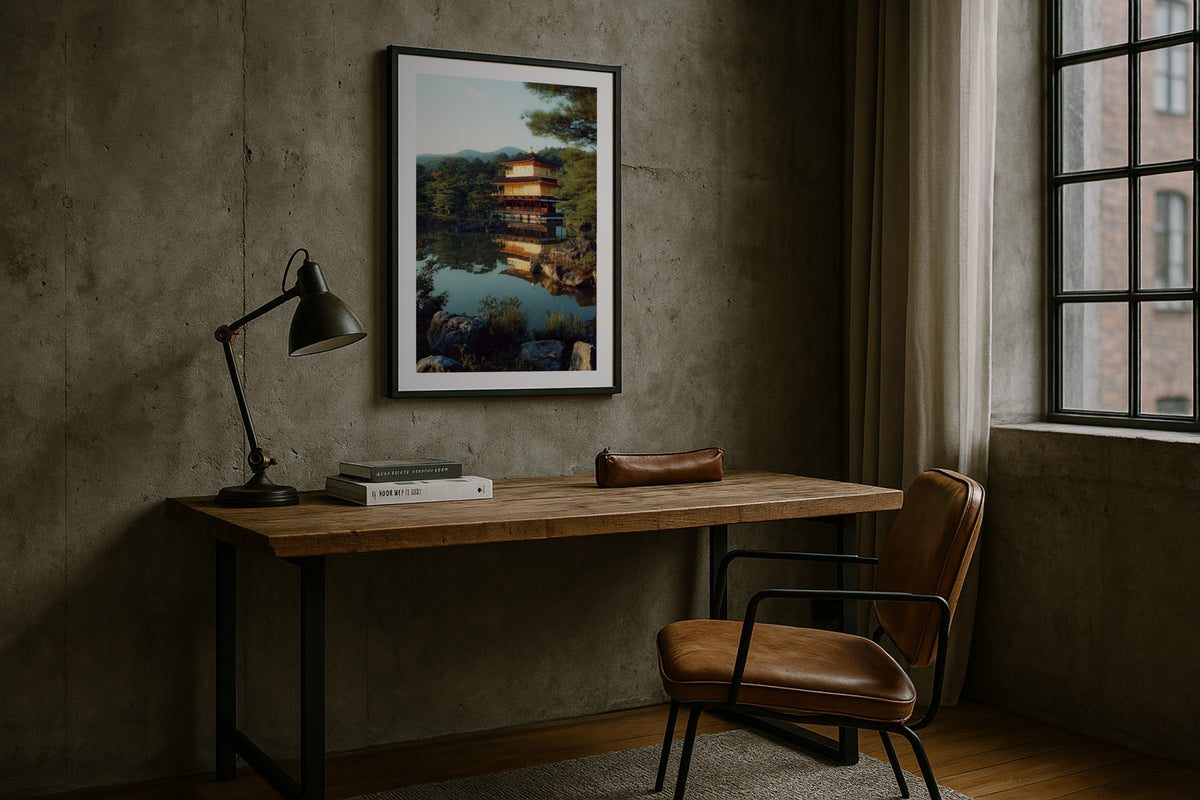 Kinkaku-ji wall art print, framed with a white border, in a concrete wall dark desk