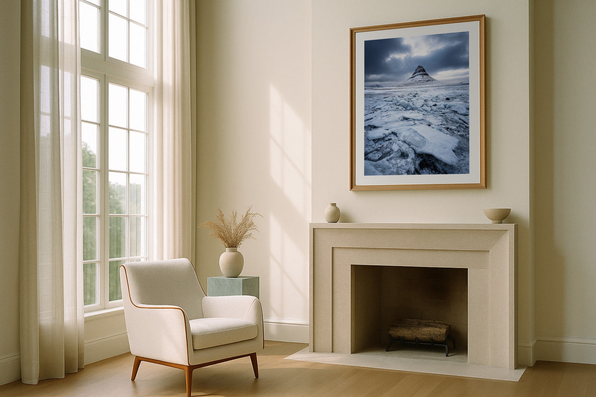Kirkjufell in Winter wall art print, framed with a white border, in a fireplace boucle chair