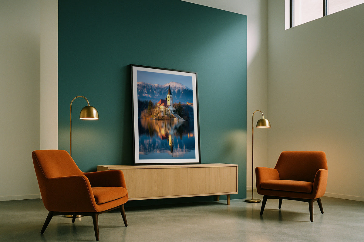 Lake Bled wall art print, framed with a white border, in a teal wall rust chairs