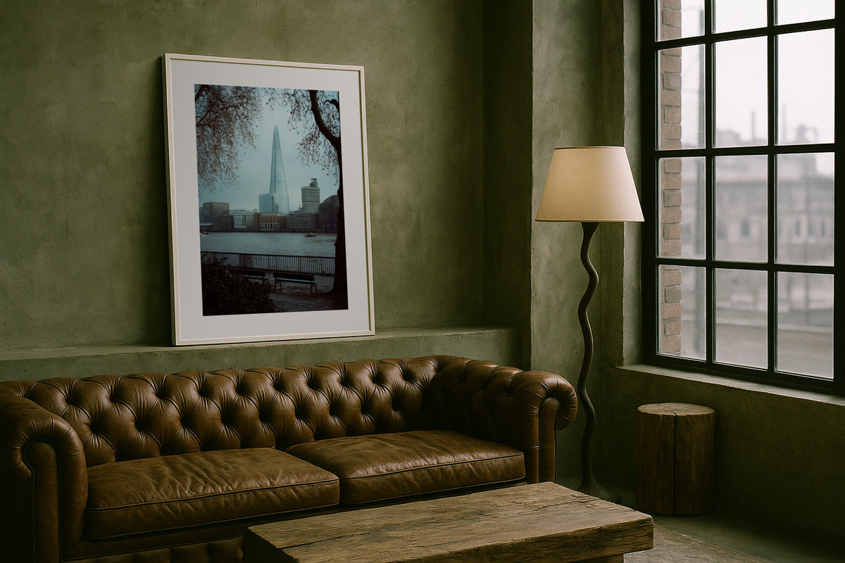 The Shard on the Thames wall art print, framed with a white border, in a chesterfield loft