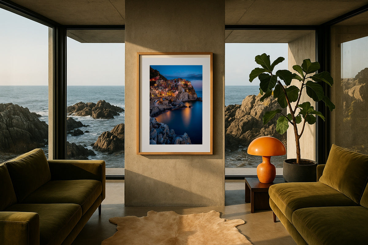 Manarola at Blue Hour wall art print, framed with a white border, in a rocky shore olive sofas