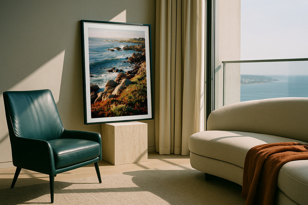 Monterey Bay wall art print, framed with a white border, in a leaning sea view leather chair