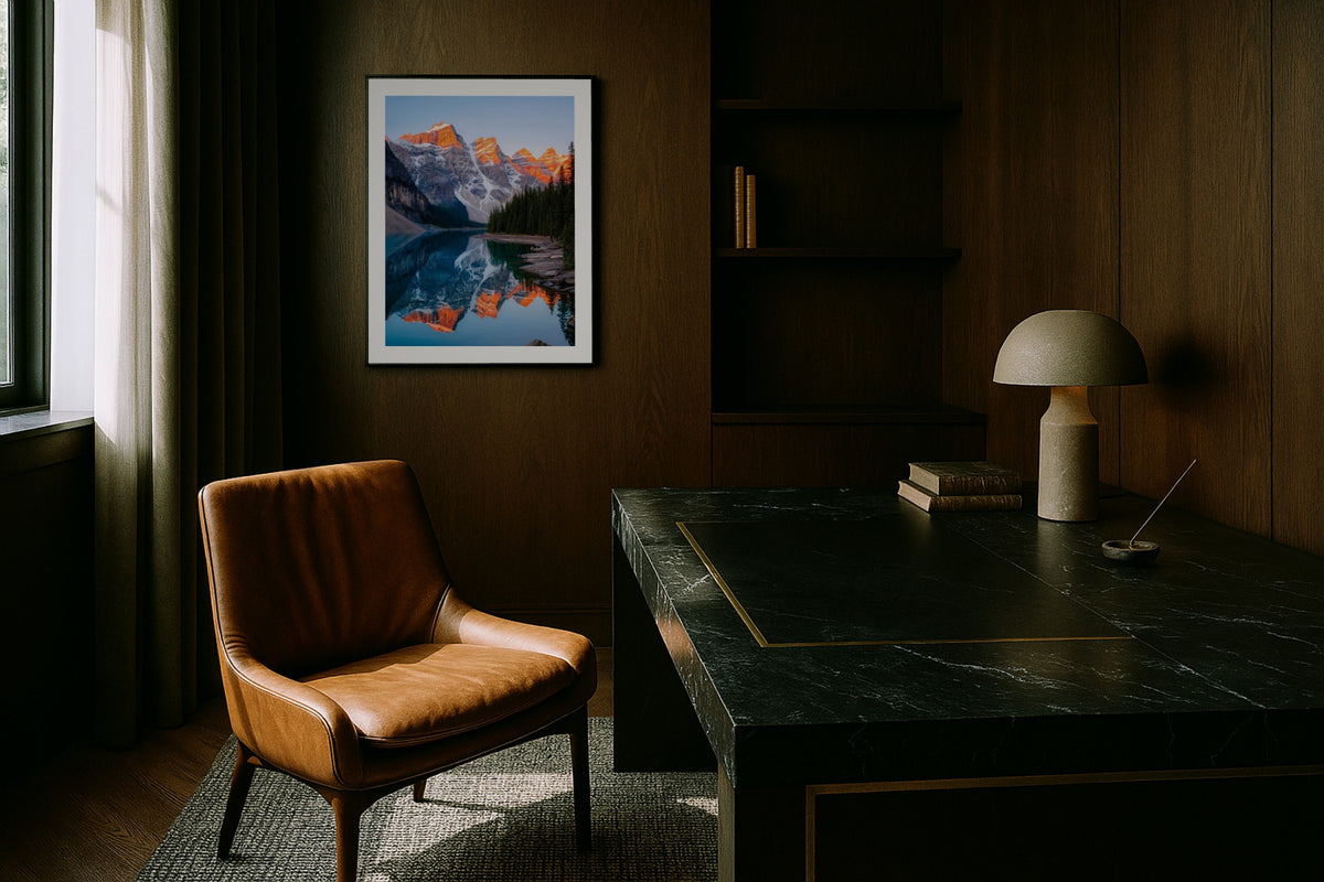 Moraine Lake at Sunrise wall art print, framed with a white border, in a dark wood office leather chair