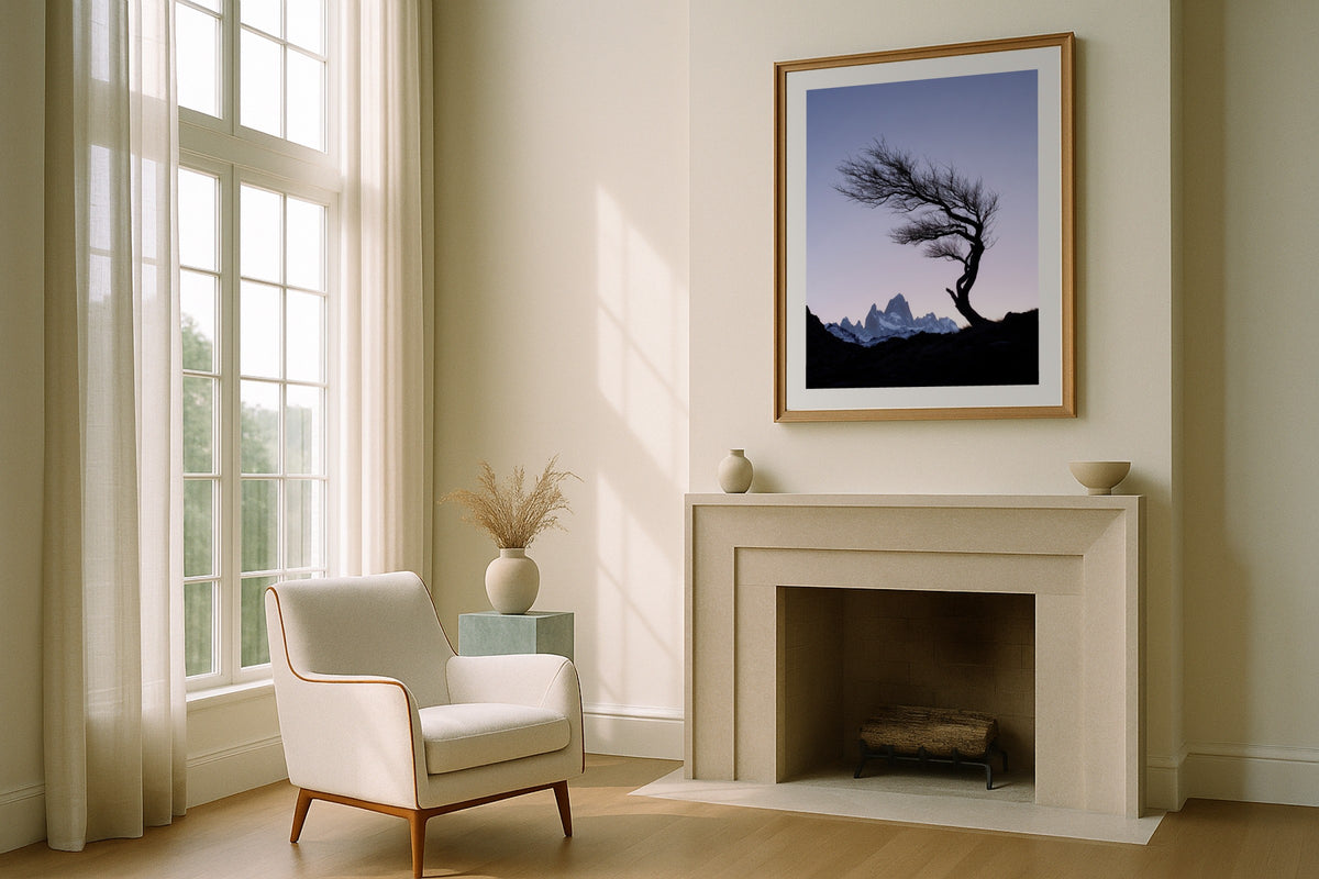 Fitz Roy at Dusk wall art print, framed with a white border, in a fireplace boucle chair