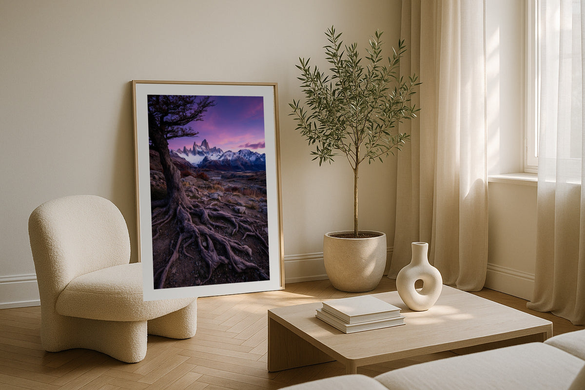 Fitz Roy in Violet wall art print, framed with a white border, in a curved sofa sconces