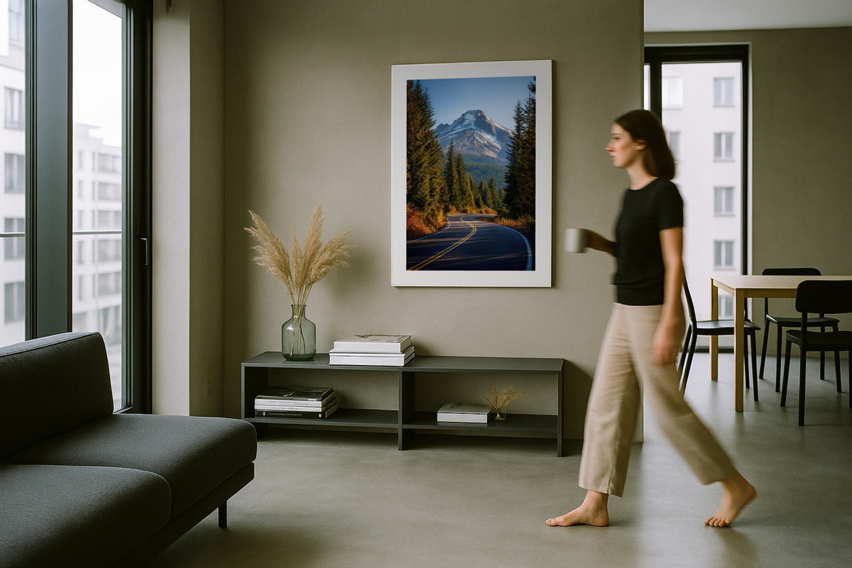 Mount Hood in Autumn wall art print, framed with a white border, in a woman walking modern grey room