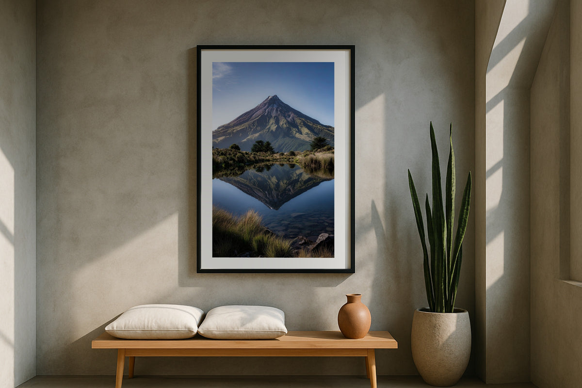 Taranaki Symmetry wall art print, framed with a white border, in a terrazzo floor magazine