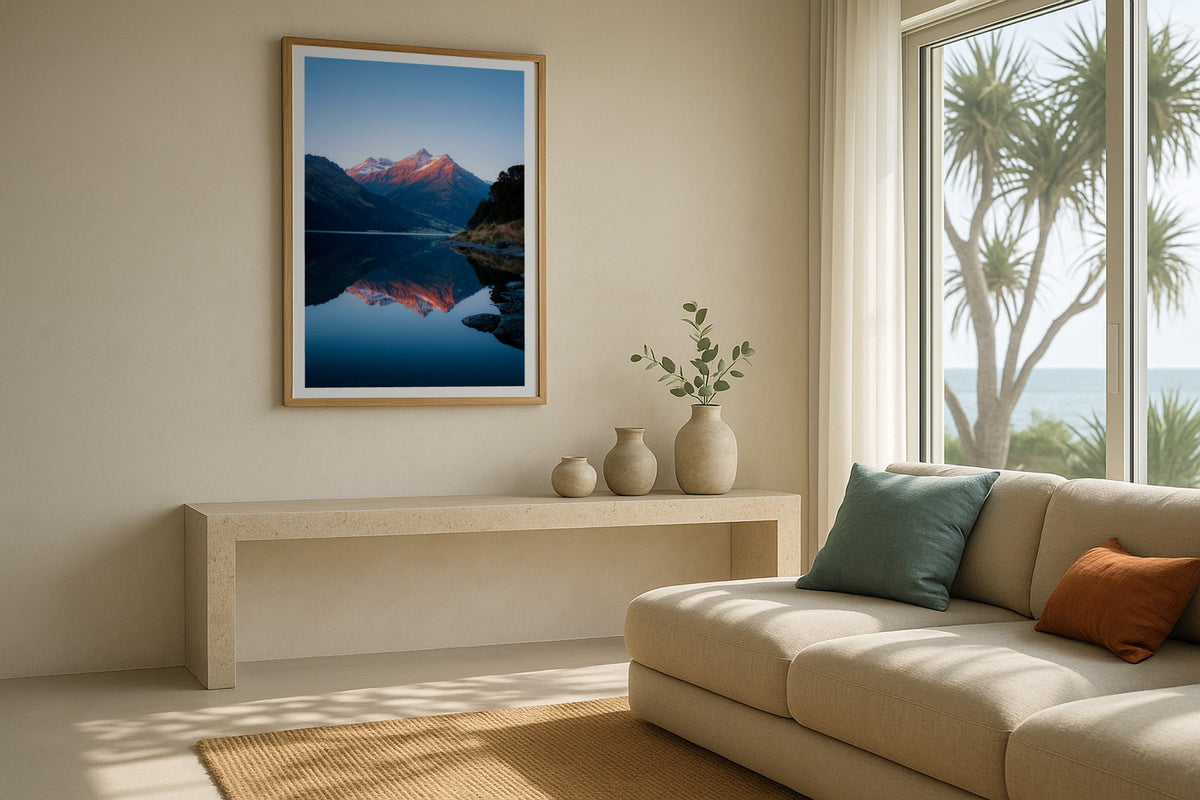 Alpenglow on Mount Aspiring wall art print, framed with a white border, in a cream minimal sofa
