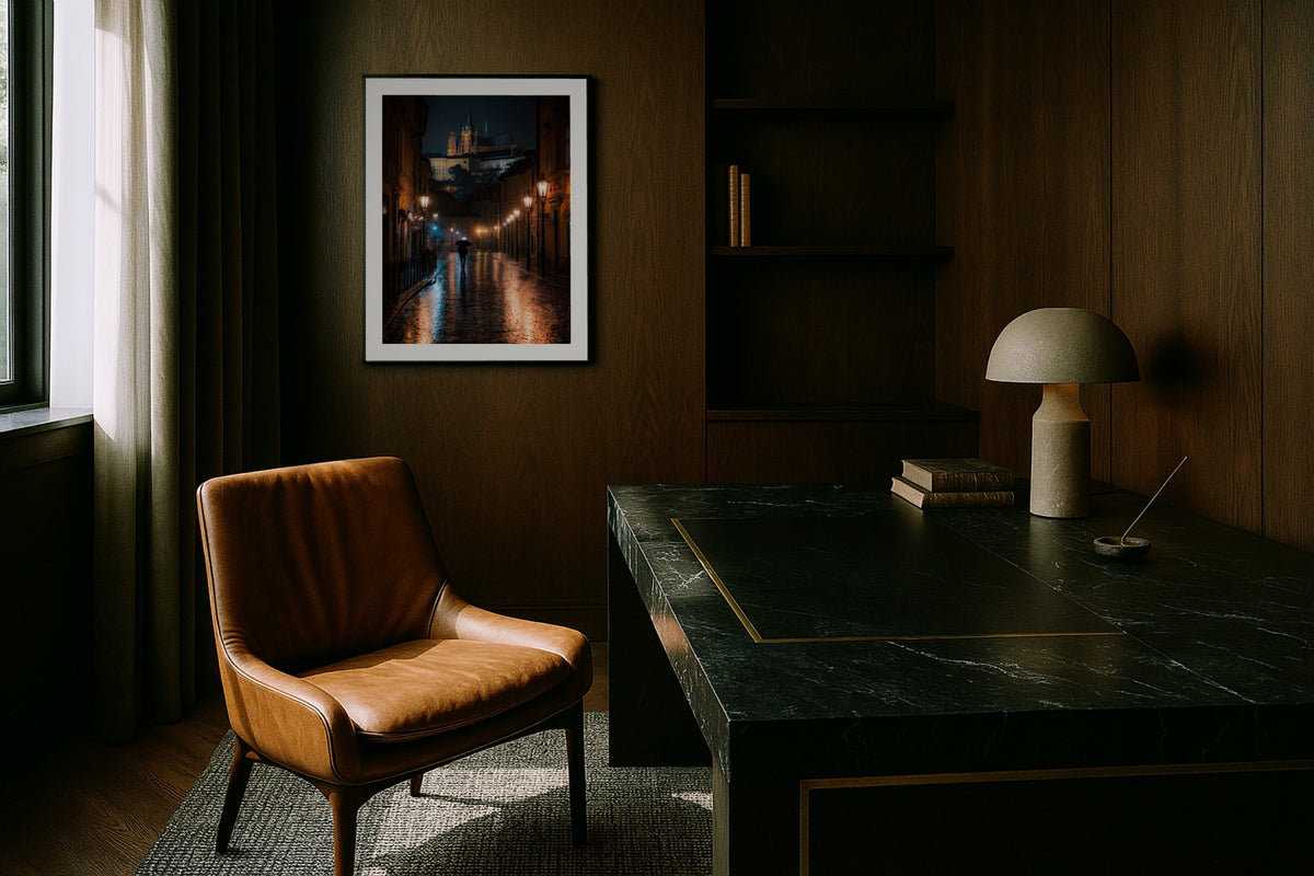 Prague in the Rain wall art print, framed with a white border, in a floor magazine leather chair