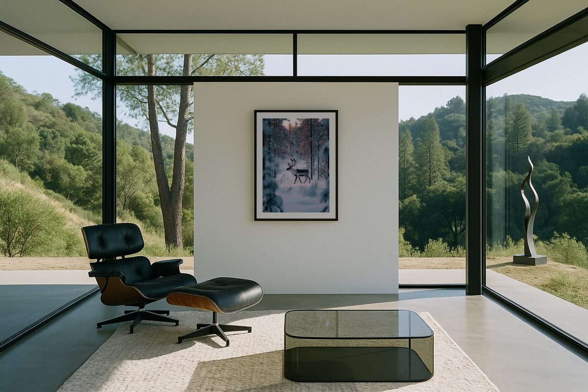Reindeer in Lapland wall art print, framed with a white border, in a forest glass Eames chair