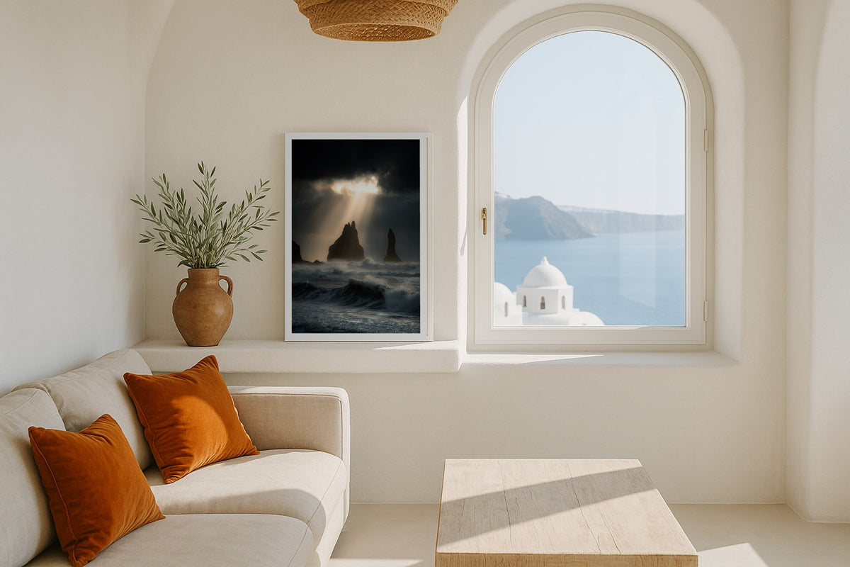 God Rays over Reynisdrangar wall art print, framed with a white border, in a Santorini white window
