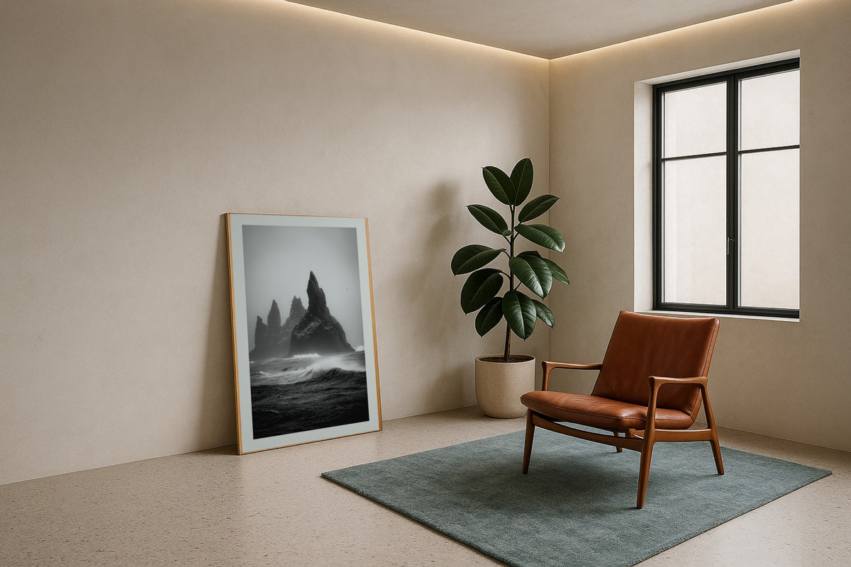 Reynisdrangar in Monochrome wall art print, framed with a white border, in a white coastal fireplace