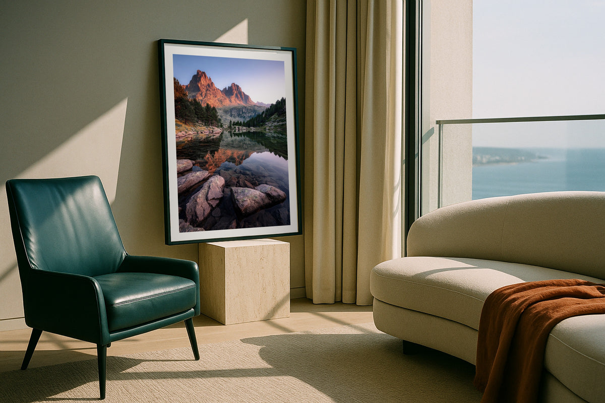 Sant Maurici wall art print, framed with a white border, in a bedside window light