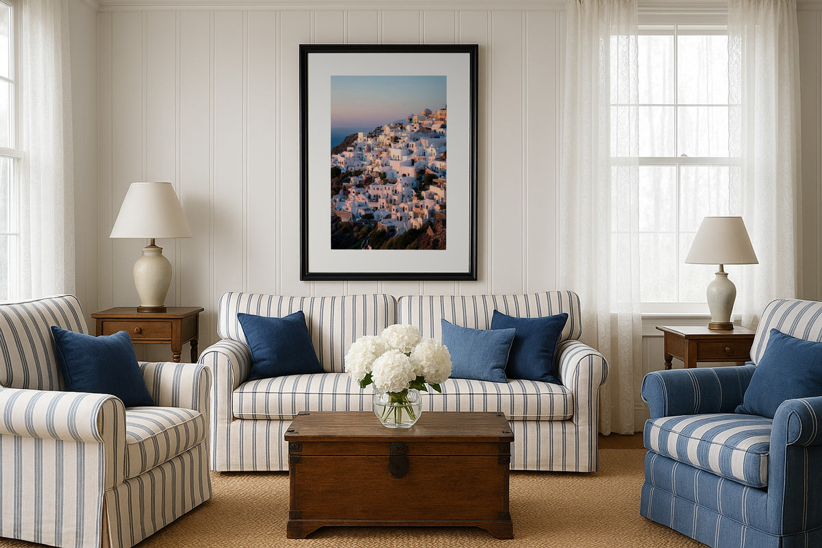 Oia Coastline wall art print, framed with a white border, in a sea view loft