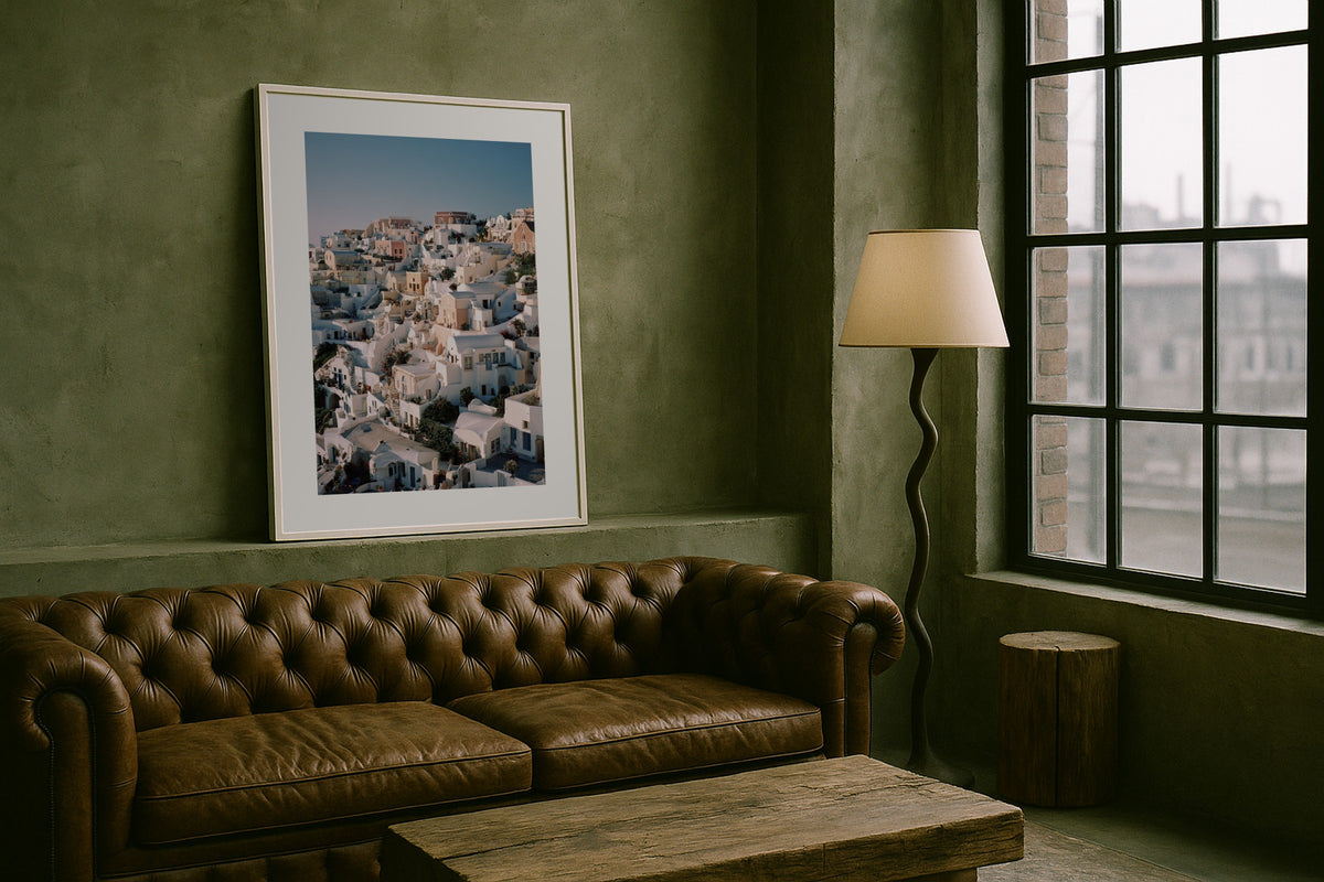 Oia Rooftops wall art print, framed with a white border, in a chesterfield loft