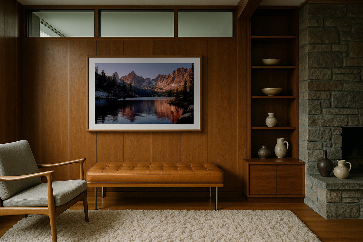 Sawtooth Mountains wall art print, framed with a white border, in a midcentury stone fireplace