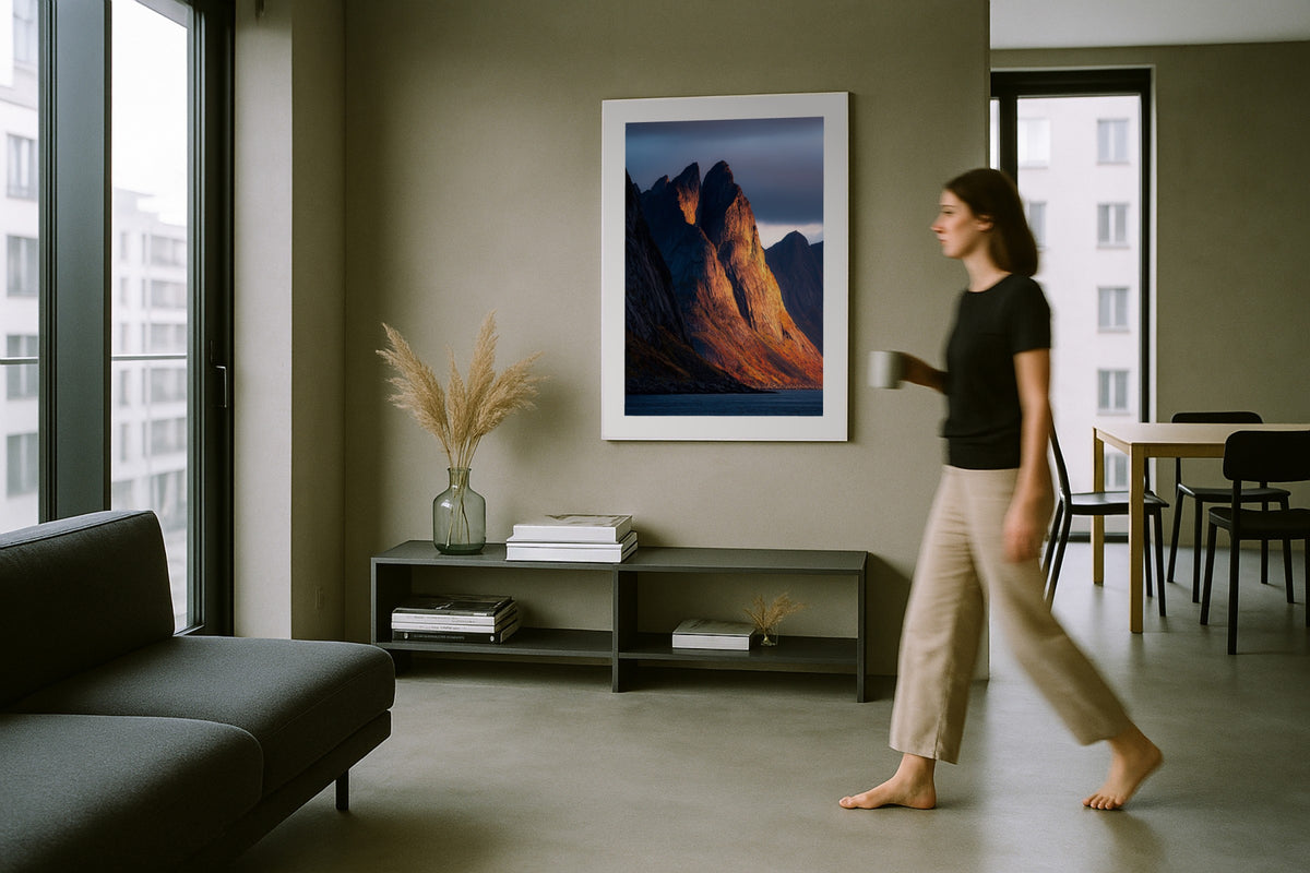 Segla Ablaze wall art print, framed with a white border, in a woman walking modern grey room