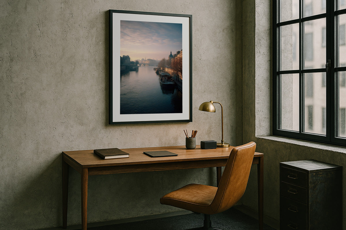 The Seine at Morning wall art print, framed with a white border, in a concrete loft desk