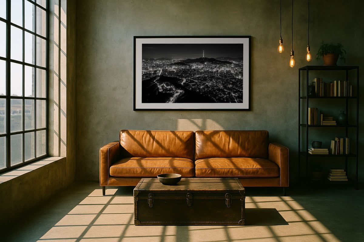 Seoul at Night wall art print, framed with a white border, in a loft leather sofa