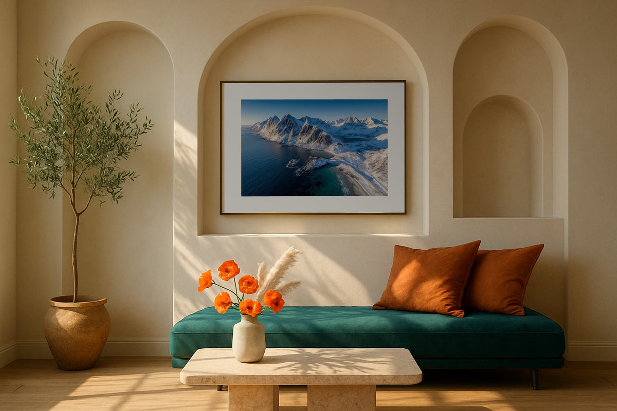 Snowy Lofoten wall art print, framed with a white border, in a white coastal fireplace