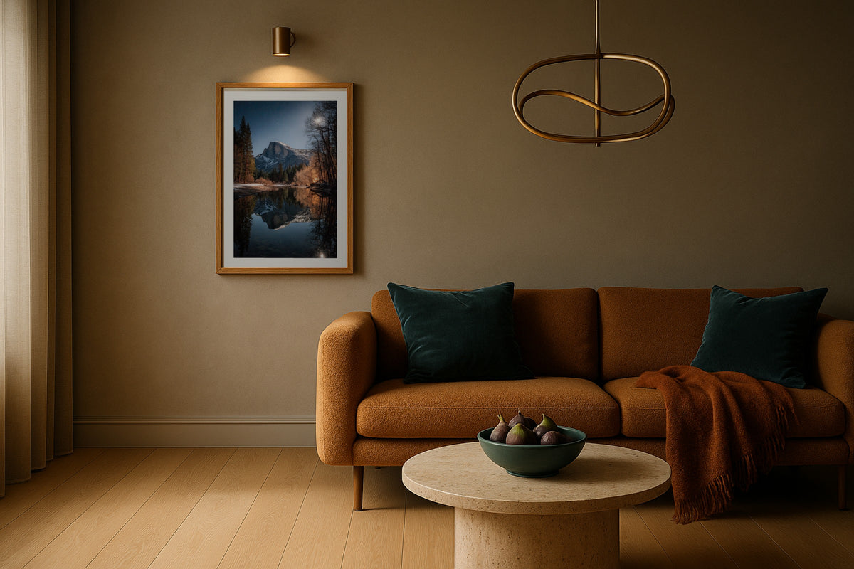 Half Dome Moonrise wall art print, framed with a white border, in a curved sofa sconces
