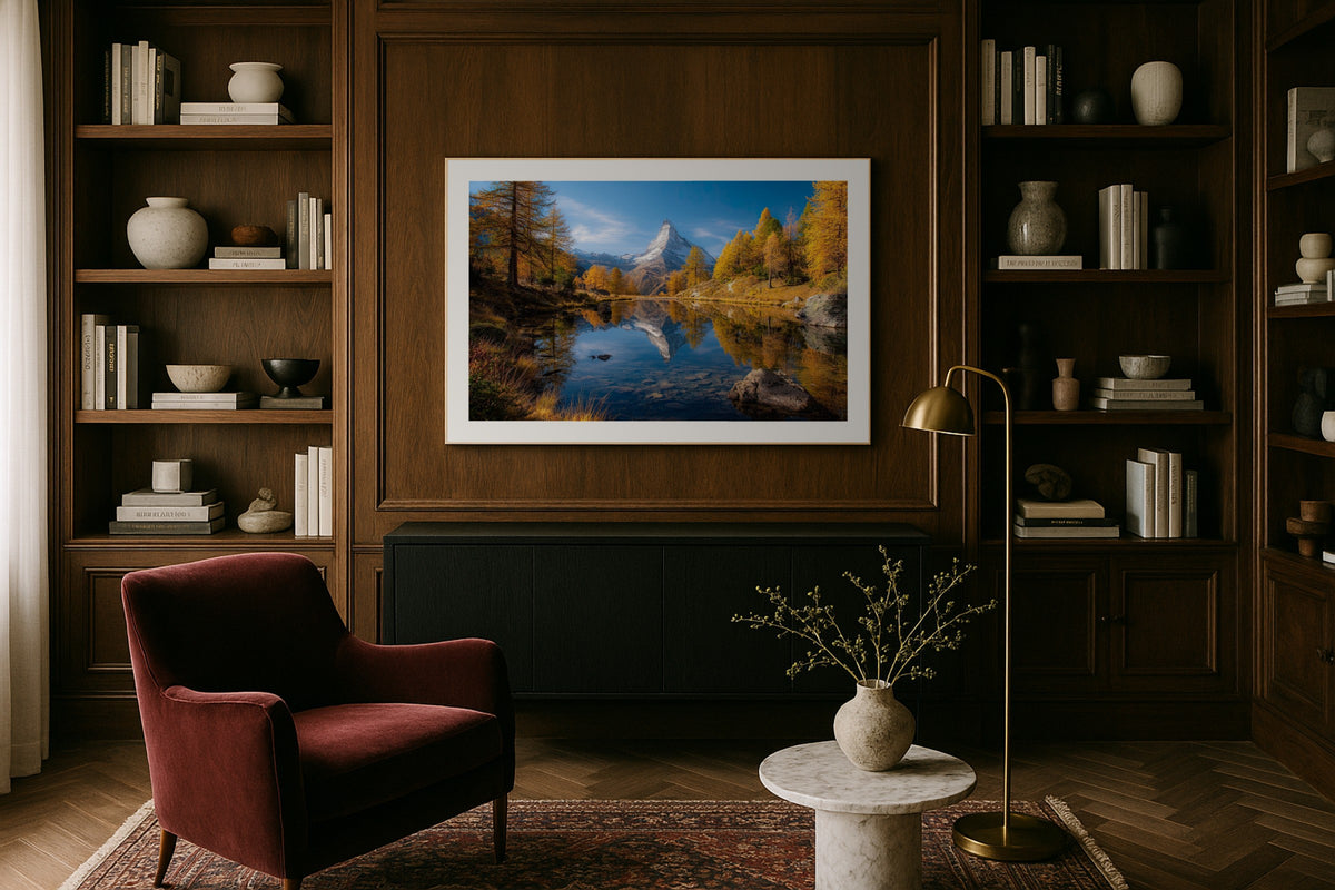 Zermatt Reflection wall art print, framed with a white border, in a library wood panels velvet chair